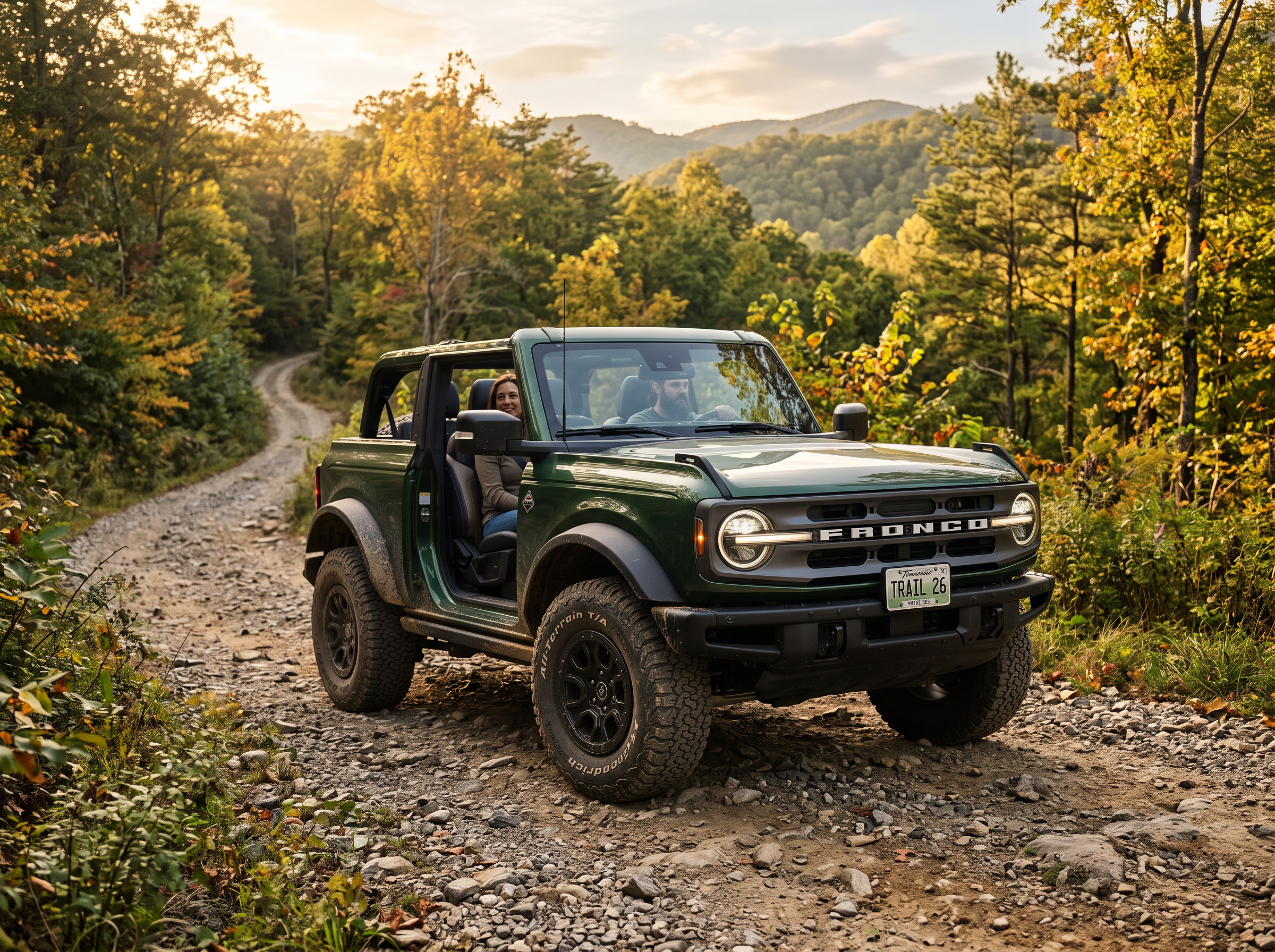 2026 Ford Bronco shown on a wooded gravel trail for adventure SUV comparison